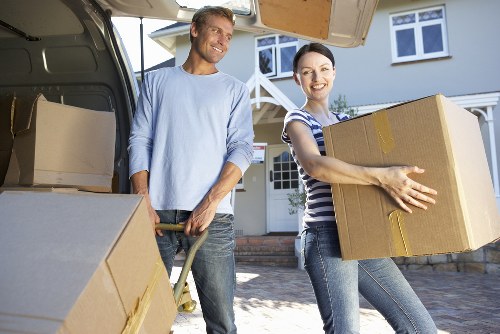 Unloading boxes and furniture at a new apartment during a Stpancras flat removal